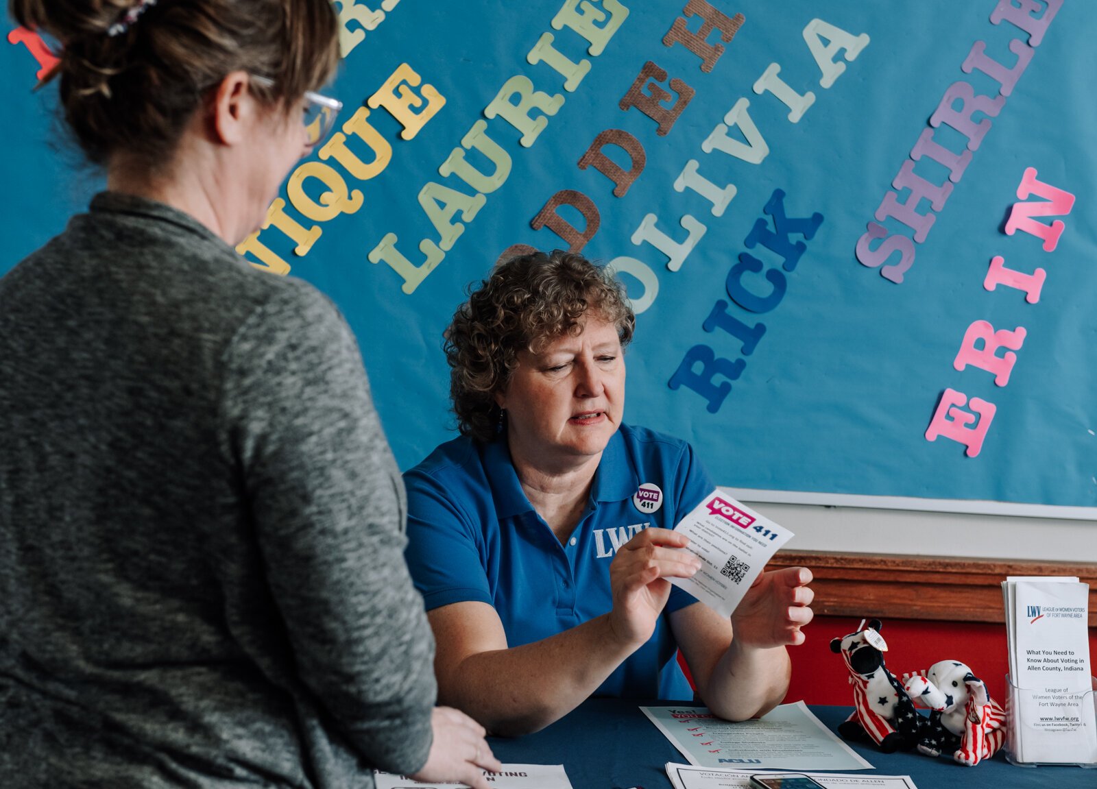 Betsy Kachmar, Co-President of League of Women Voters of Fort Wayne, right,  talks with Chris Castaldi about voting at the Allen County Public Library Tecumseh branch.