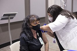 Marsha Franklin, a respiratory therapist at Parkview Regional Medical Center, receives her first dose of the COVID-19 vaccine on Dec. 14, 2020, from Maryam Noureldin, ambulatory pharmacist. 