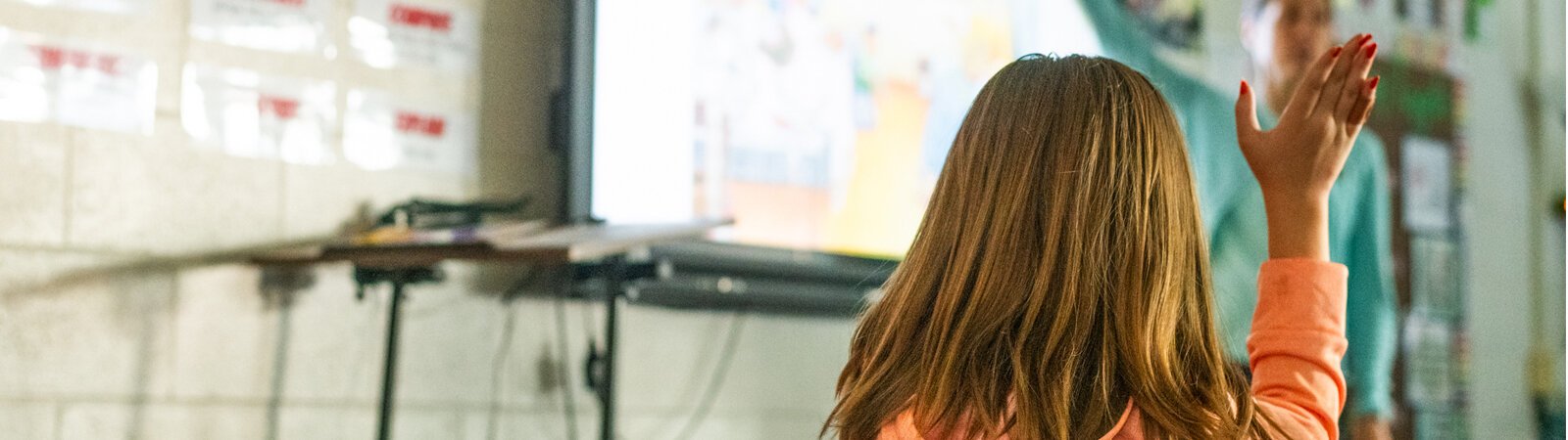 A student at Manchester Intermediate School raises their hand.