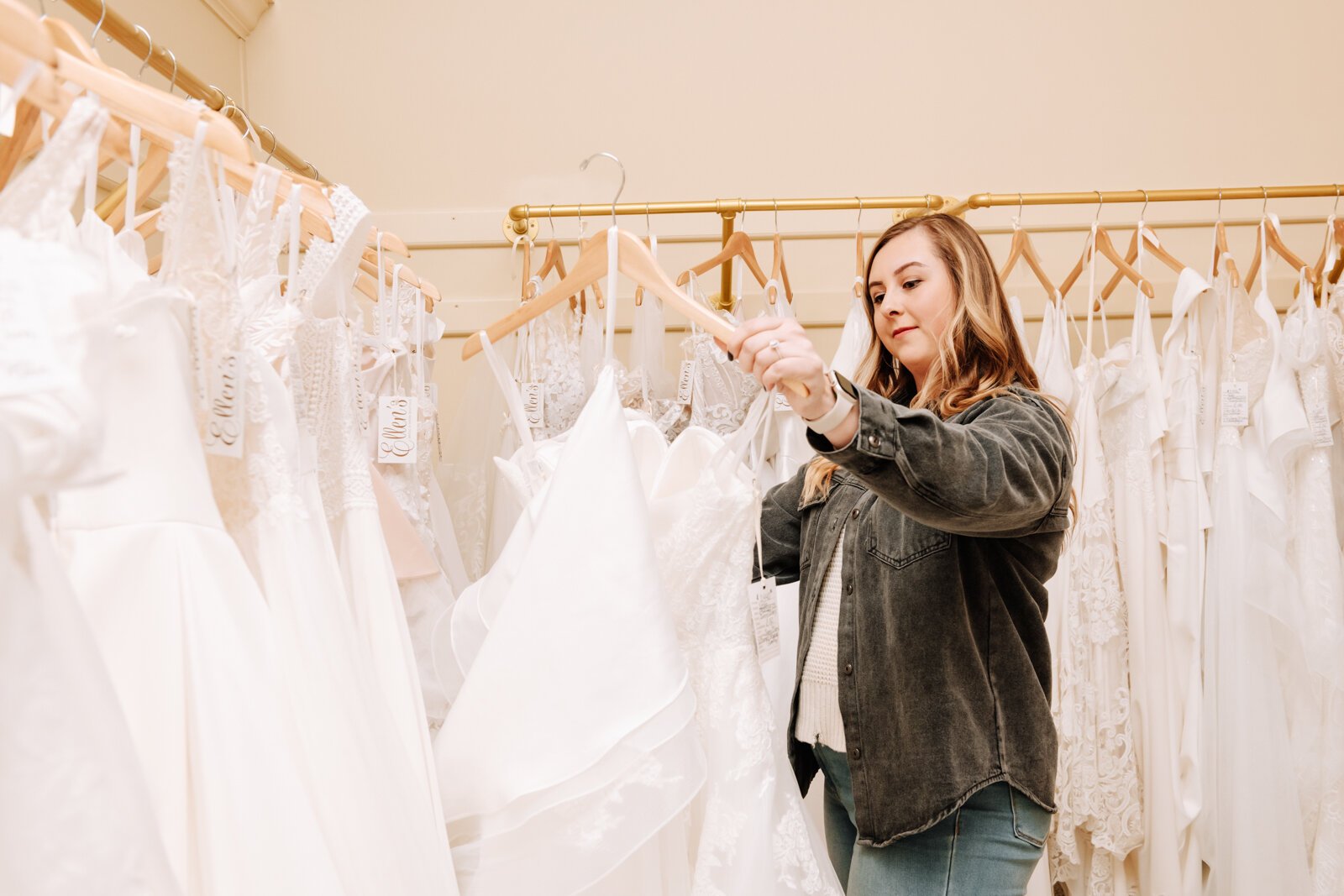 Bride Bailey Lundmark looks at dresses available at Ellen's Bridal & Dress Boutique.
