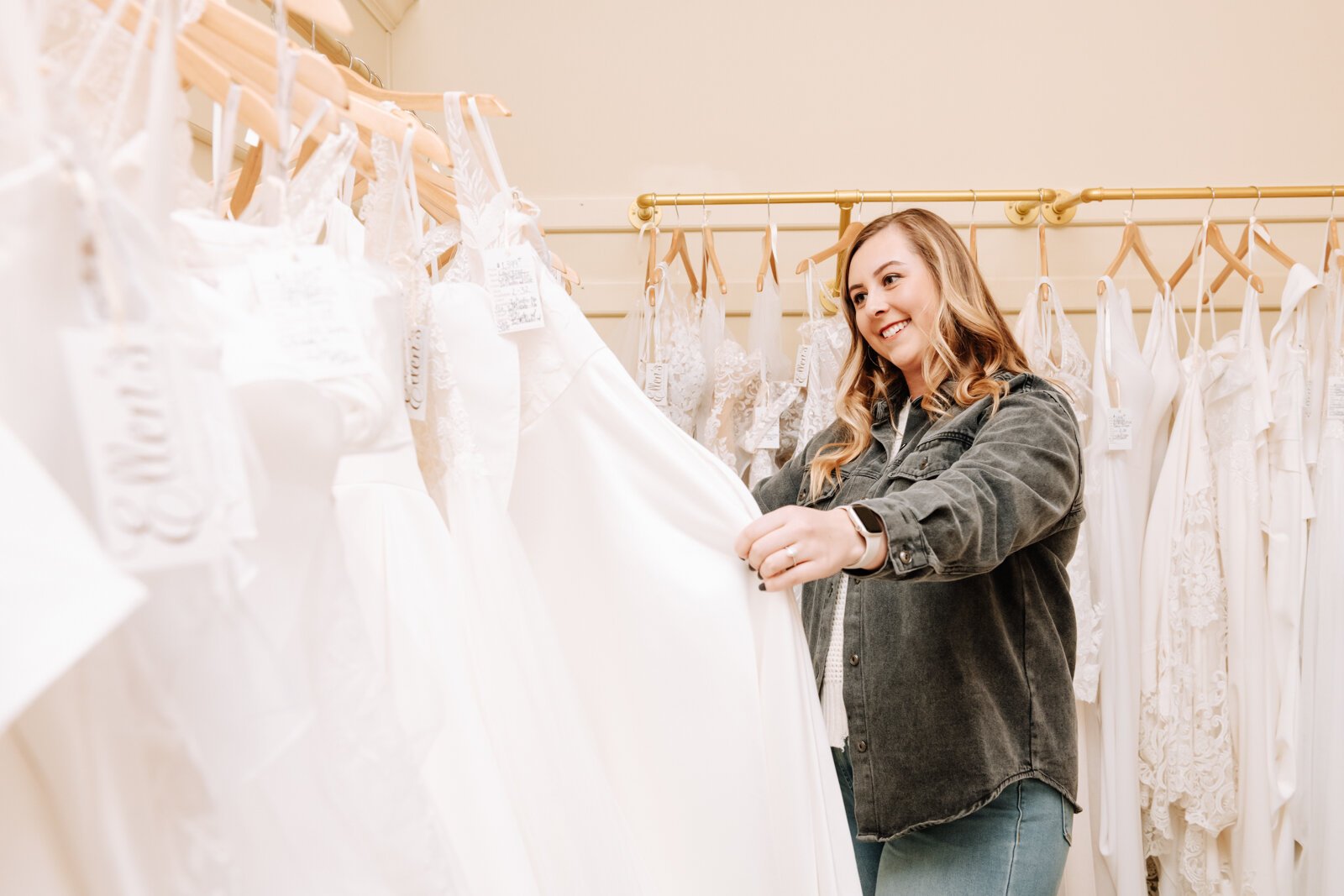 Bride Bailey Lundmark looks at dresses available at Ellen's Bridal & Dress Boutique.