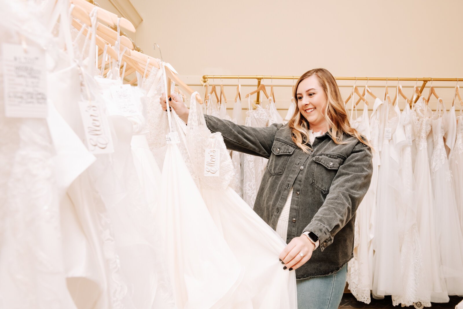 Bride Bailey Lundmark looks at dresses available at Ellen's Bridal & Dress Boutique.