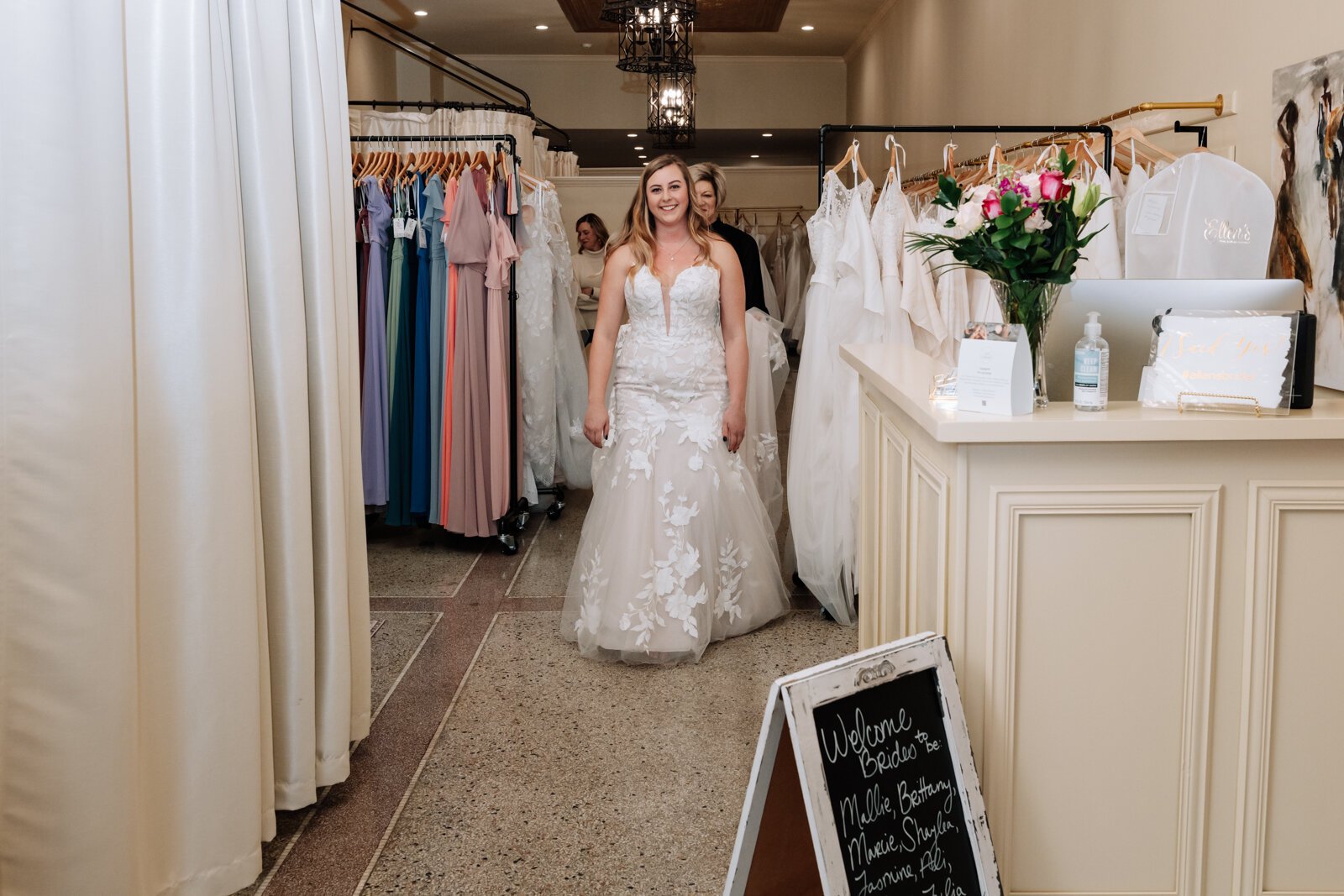 Bride Bailey Lundmark shows off a wedding dress she tried on at  Ellen's Bridal & Dress Boutique.