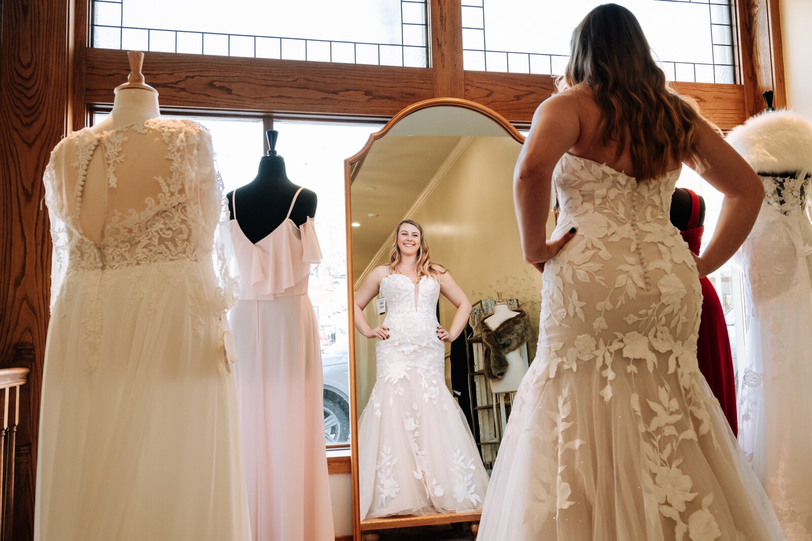 Bride Bailey Lundmark shows off a wedding dress she tried on at  Ellen's Bridal & Dress Boutique.