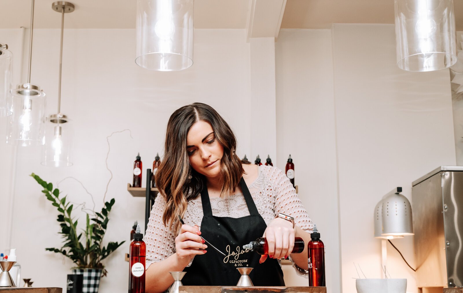 Abby Ward mixes together scents to make a Valentine's Day candle at JoJo's OlFactory Co.