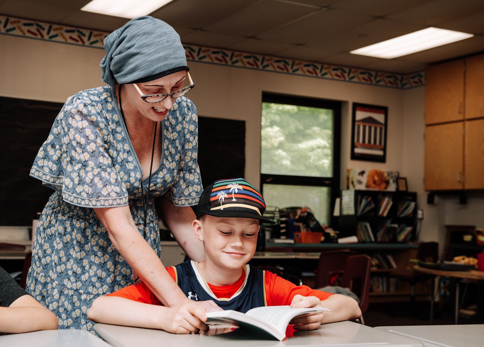 Keri Mertz helps student Camden McKee with his book in her classroom at O J Neighbours Elementary School in Wabash.