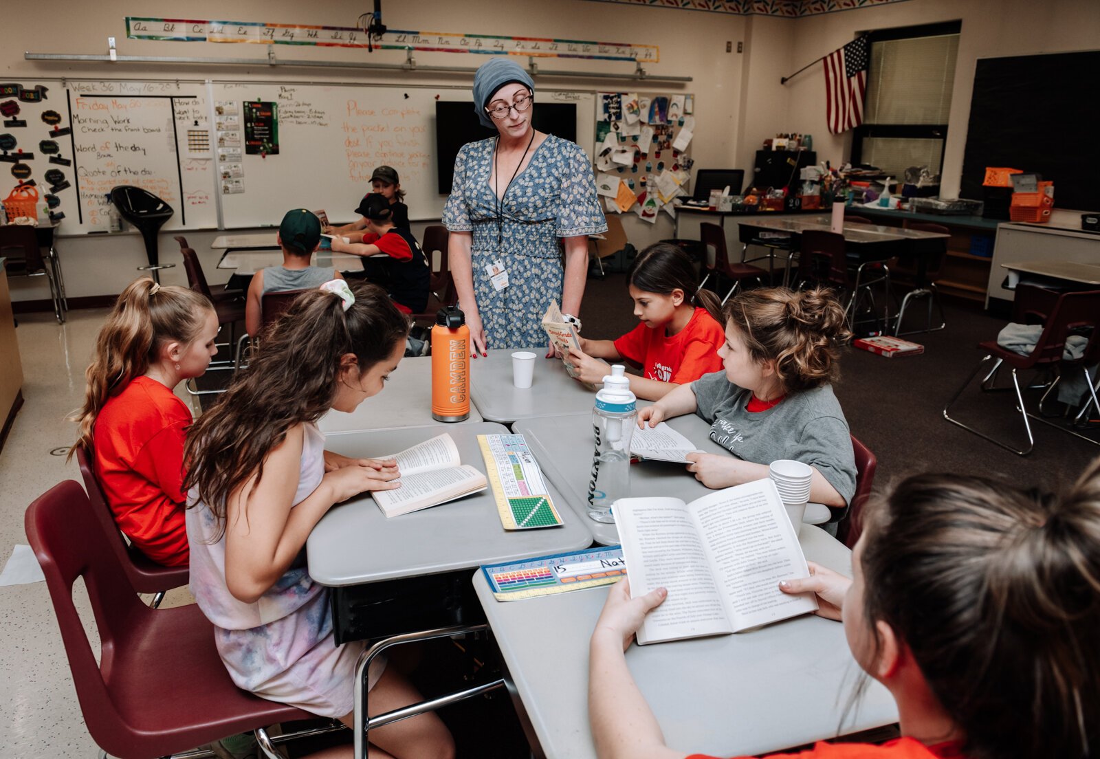 Keri Mertz helps students with their books in her classroom at O J Neighbours Elementary School in Wabash.