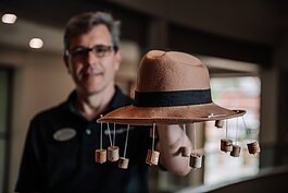 Brian Kruschwitz, Education Artistic Manager at Honeywell Foundation shows off  a hat that helps swat away flies that he uses for storytelling at the Honeywell Center.