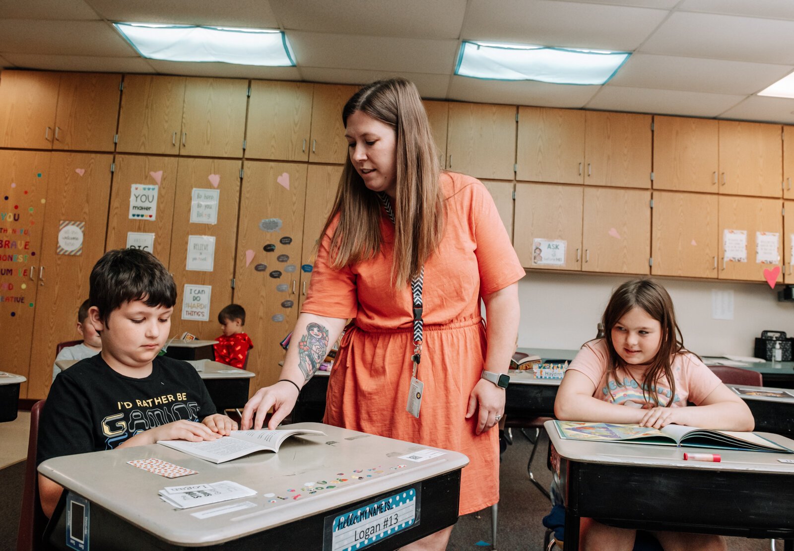 Teacher Stacey Fry helps students Logan Minard, left, Hunter Lutz during reading time in her class at O J Neighbours Elementary School in Wabash.