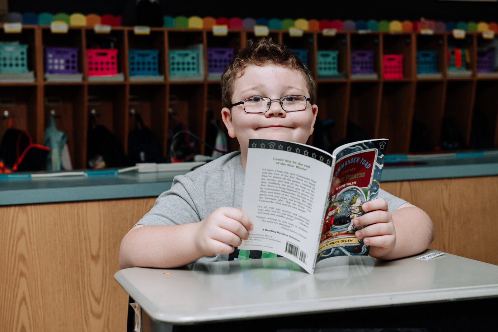 Westyn Stevens poses with his book during reading time in teacher Stacey Fry's class at O J Neighbours Elementary School in Wabash.