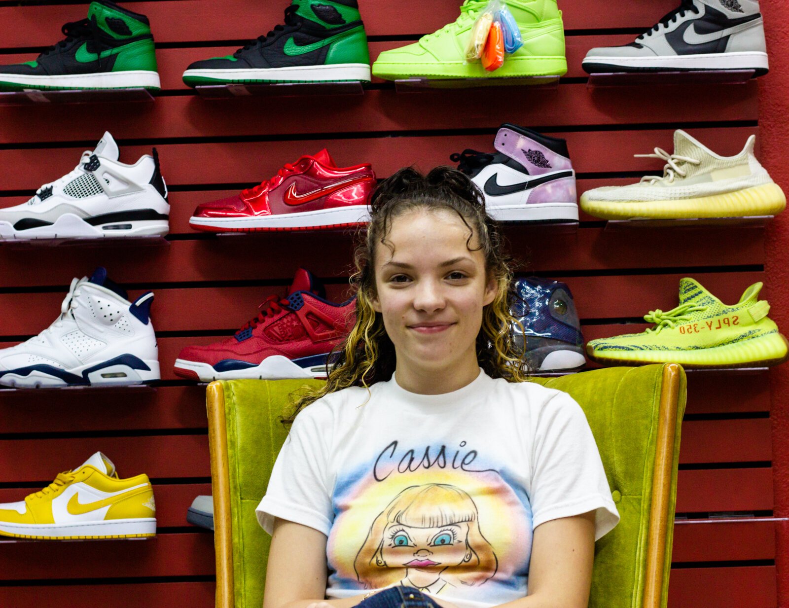 Caitlin Dostal of Deadstock Vintage in front of the sneaker wall.