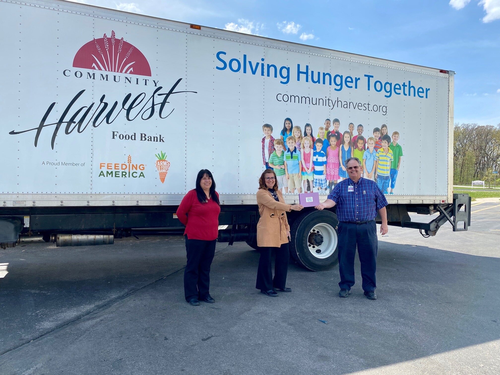 The organization 100+ Women Who Care donated $30,000 to the Community Harvest Food Bank.