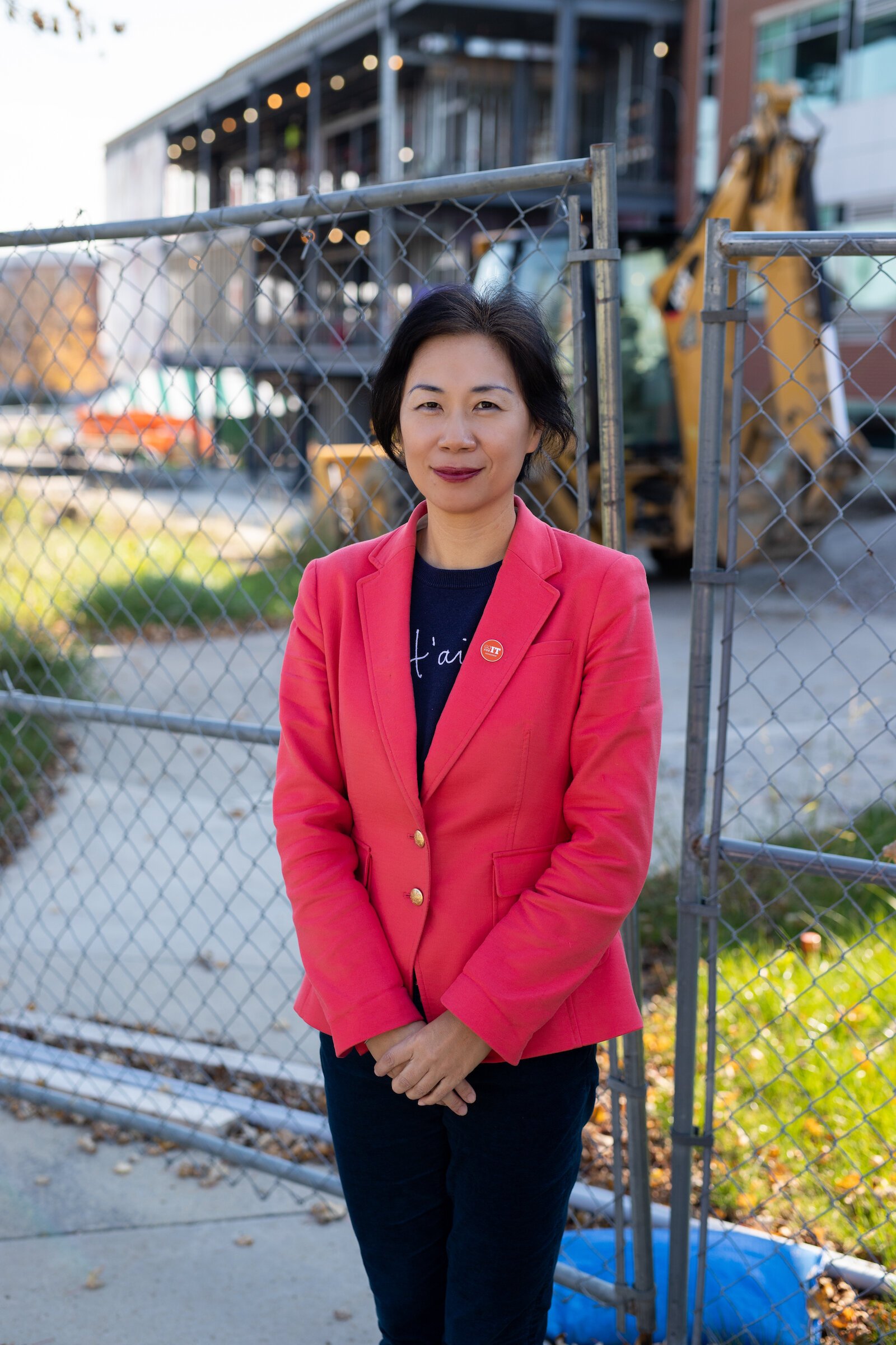 Dr. Ying Shang stands in front of the Zollner Engineering Center at Indiana Tech, which is under construction to double its size.