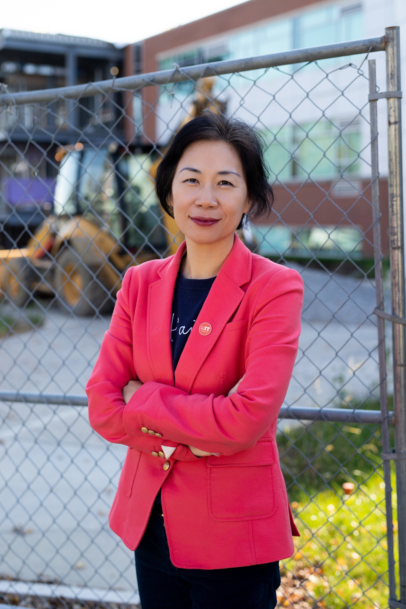 Dr. Ying Shang stands in front of the Zollner Engineering Center at Indiana Tech, which is under construction to double its size.