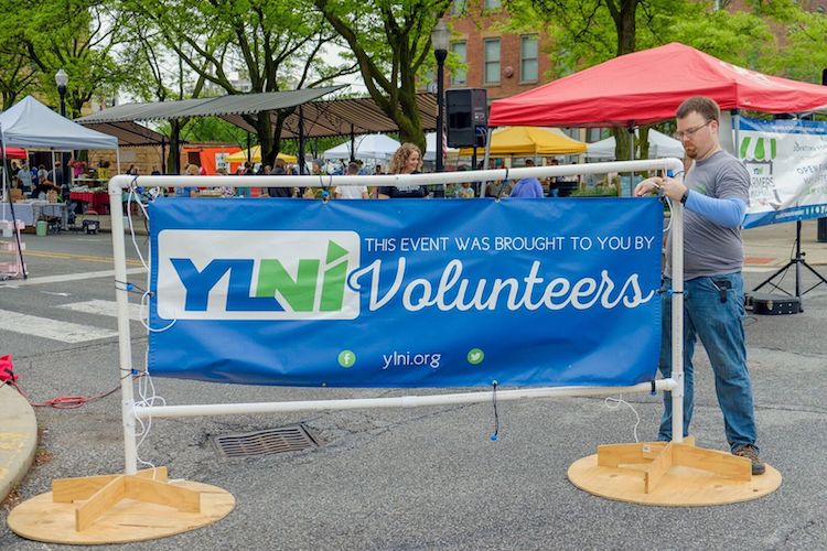 YLNI volunteers arrive early to help set up for the Barr Street Market.