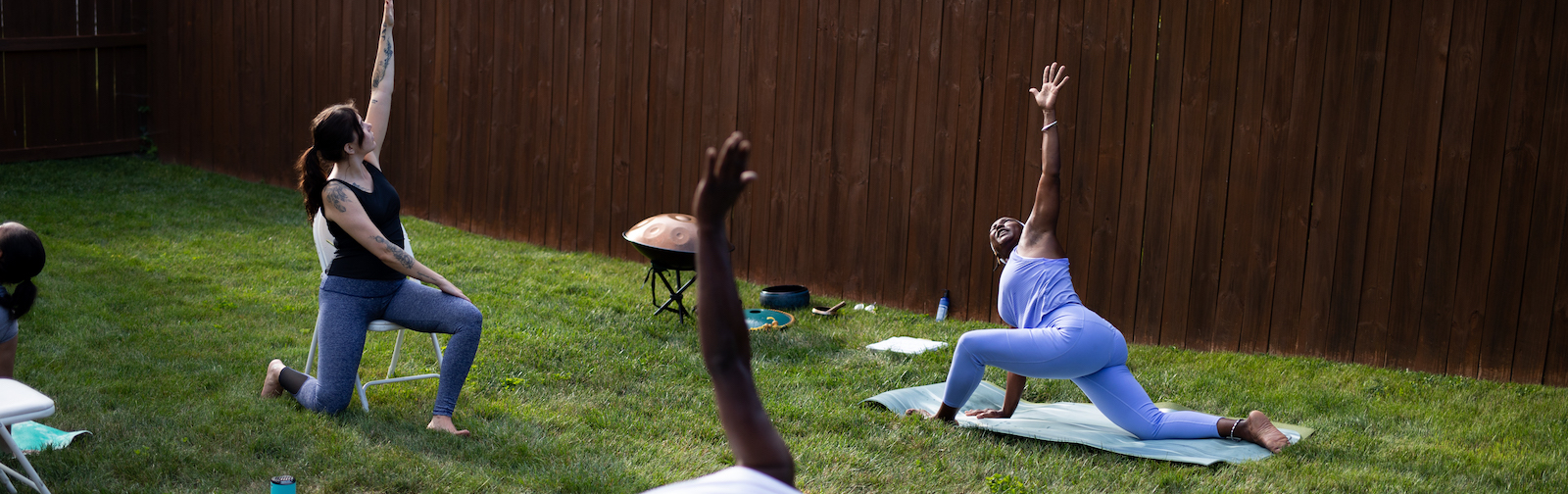 Diane Rogers, right, and Haley Evans, left, lead a Rooted Connection yoga class in South East Fort Wayne.