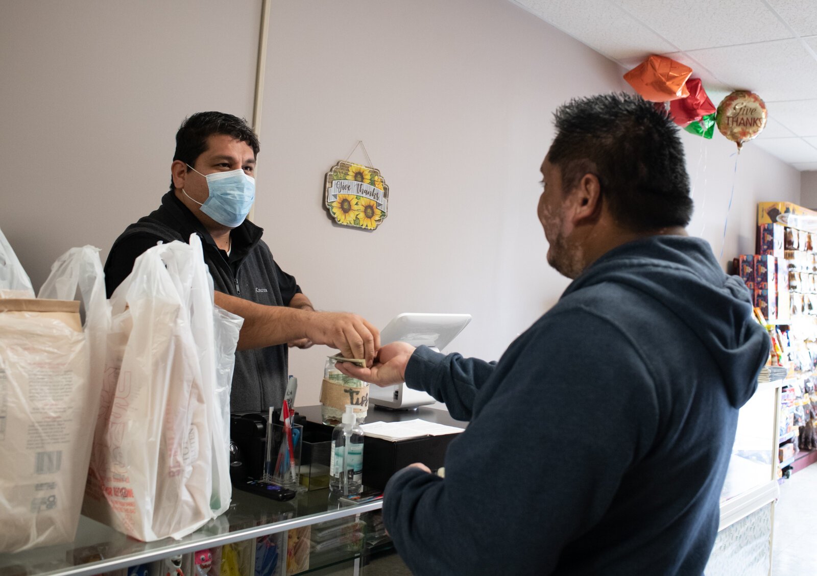 Carlos Peña helps a customer at Zion.